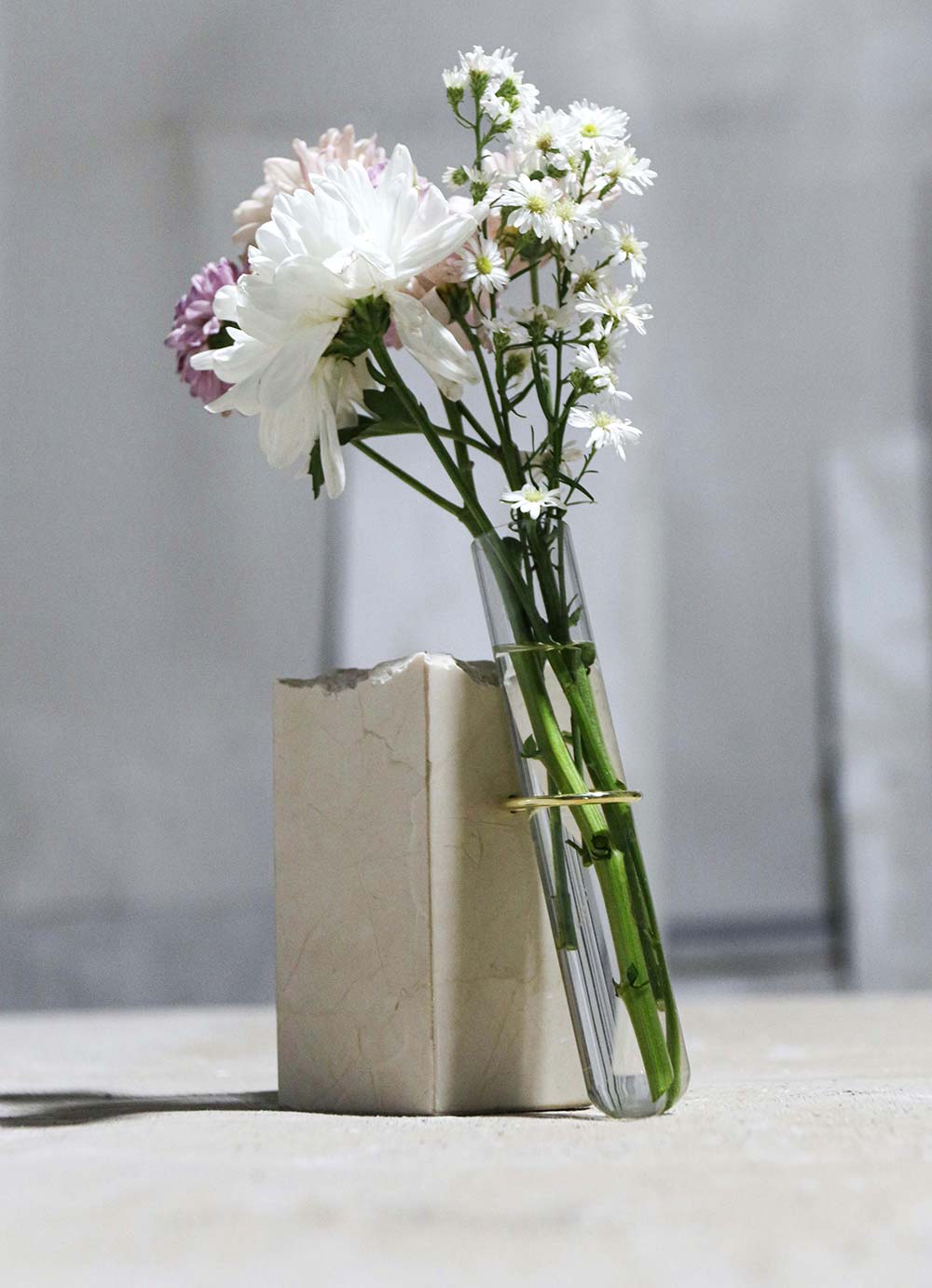 a vase filled with flowers sitting on top of a table