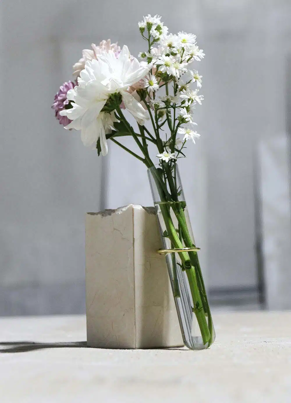 a vase filled with flowers sitting on top of a table