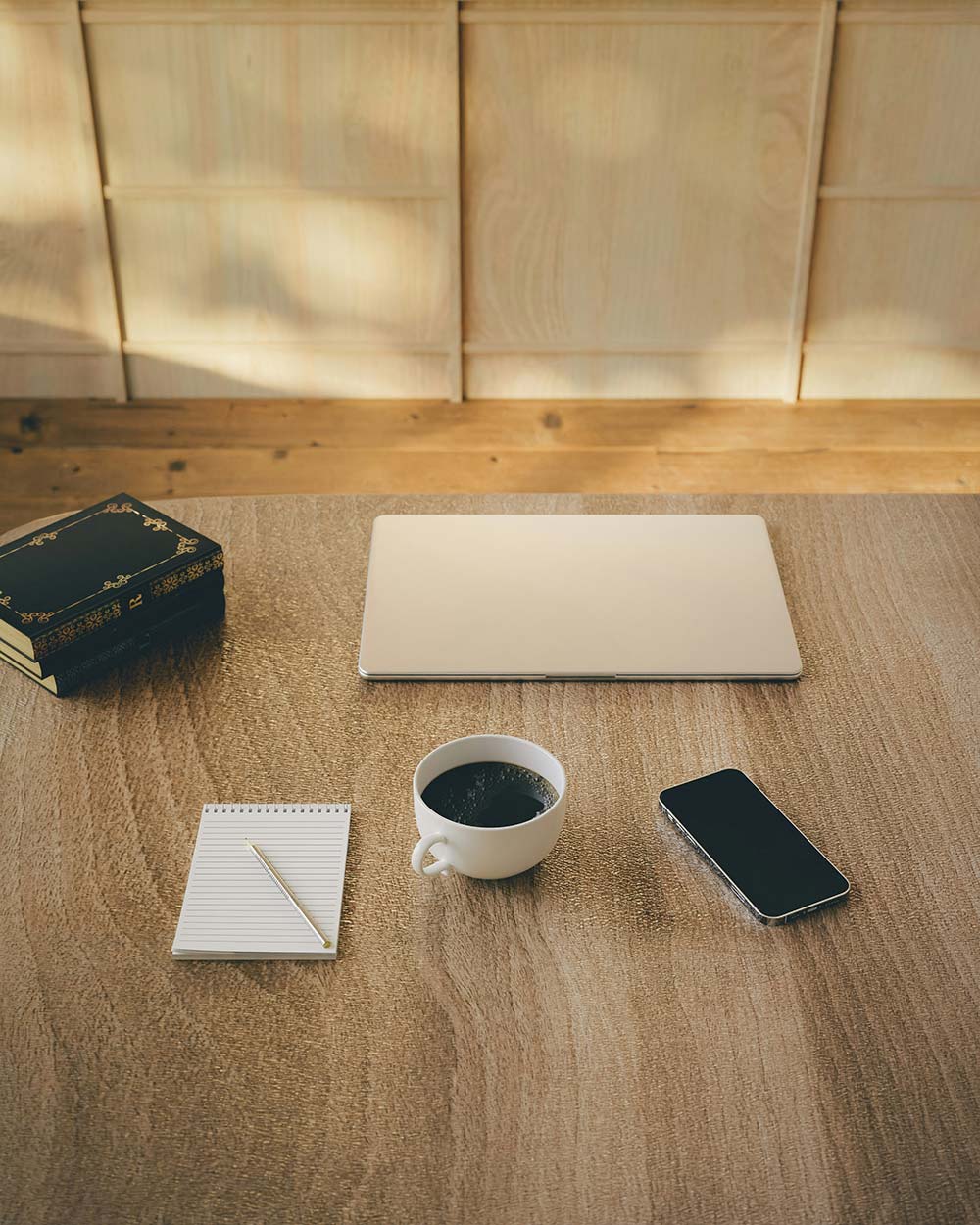 a coffee cup and a cell phone on a table