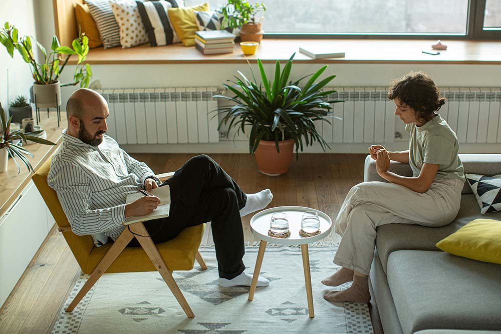 A man and a woman sitting on a couch.